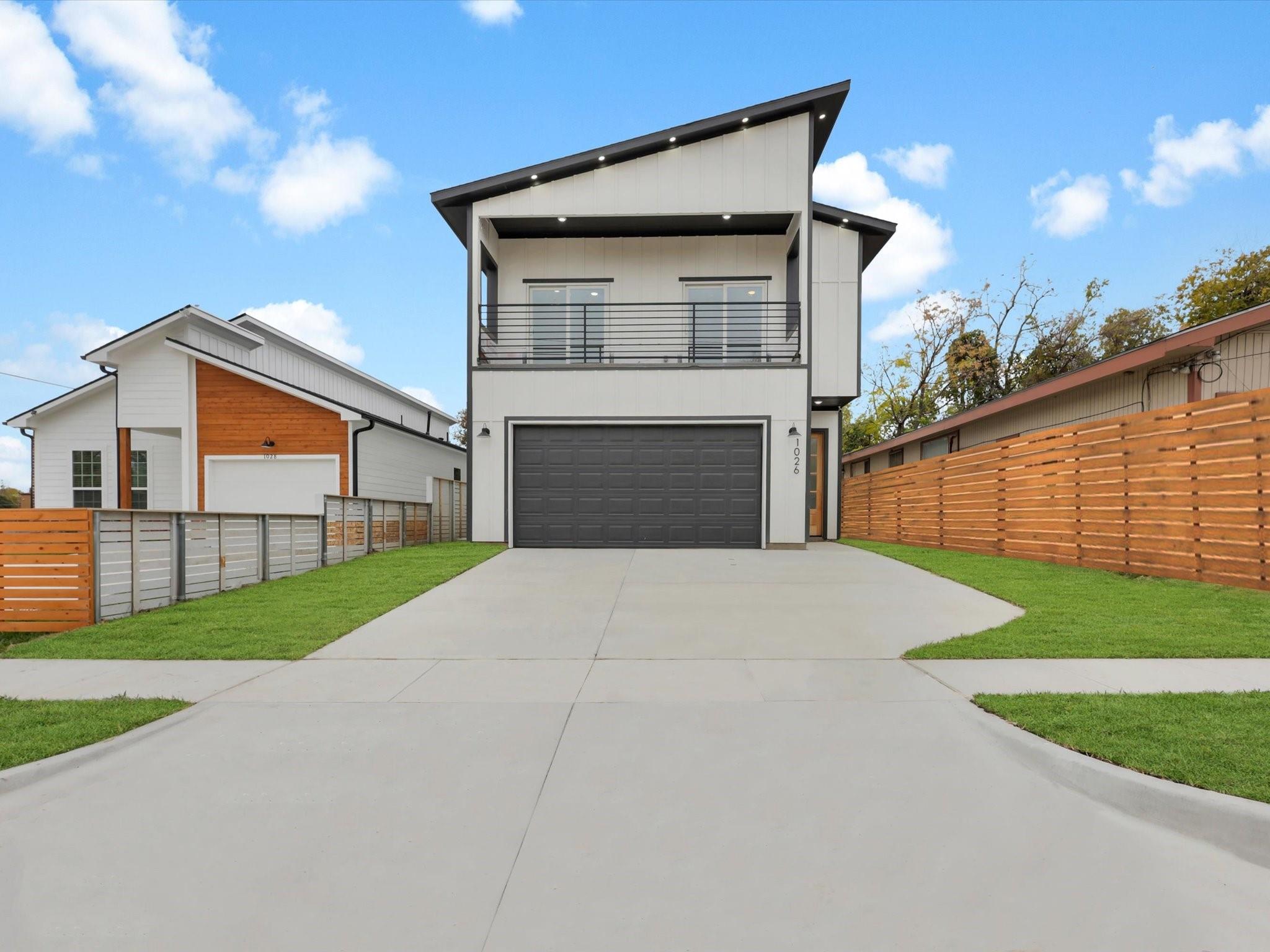 Modern luxury apartment tower at sunset, glass and steel facade, warm amber light, dark sky backdrop, architectural photography